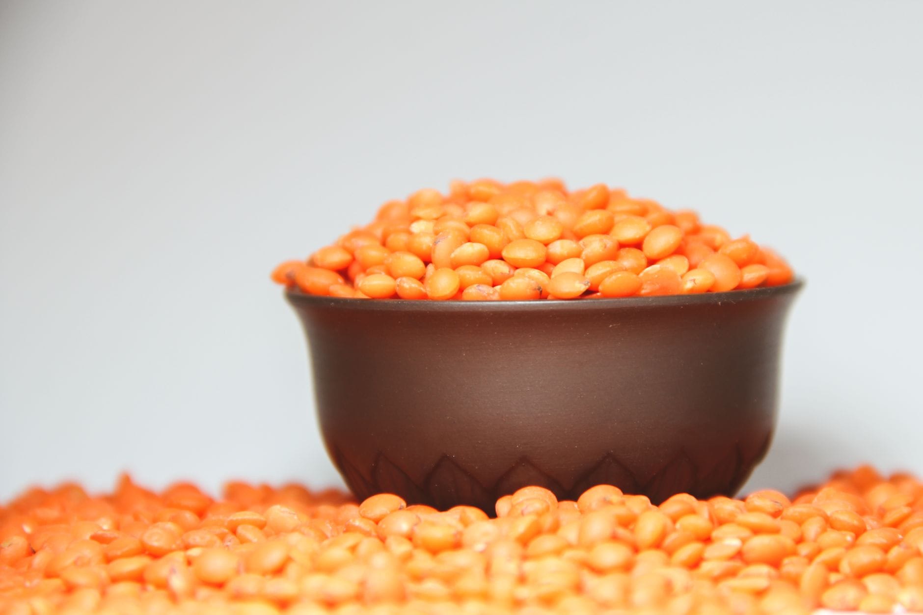 Small bowl overflowing with dried red lentils