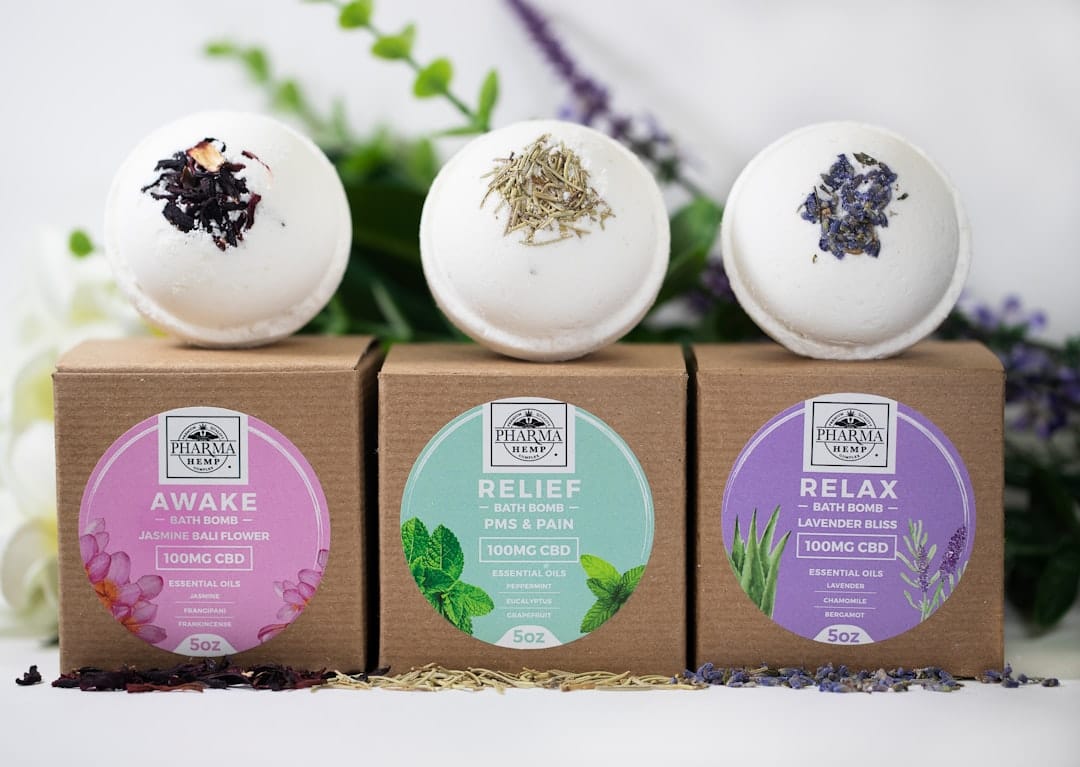 Three CBD bath bombs displayed on their packaging boxes
