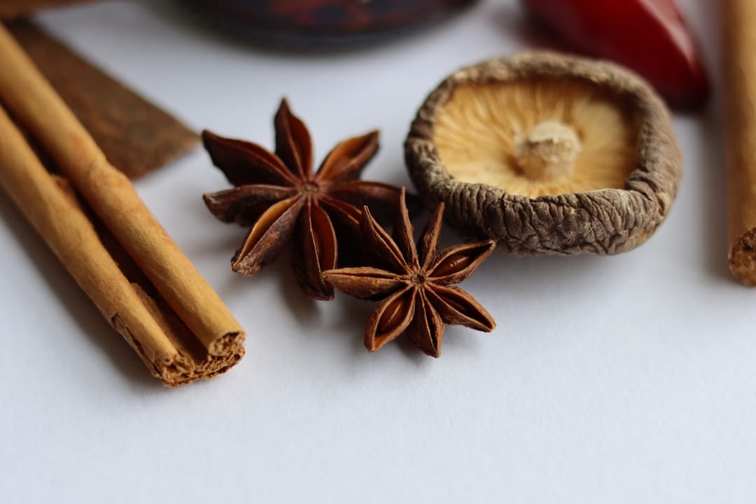 Cinnamon sticks, star anise, and a dried mushroom on a counter