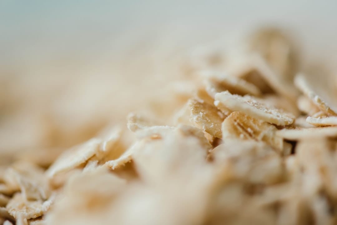 Extreme close-up of rolled oat flakes in soft pale light