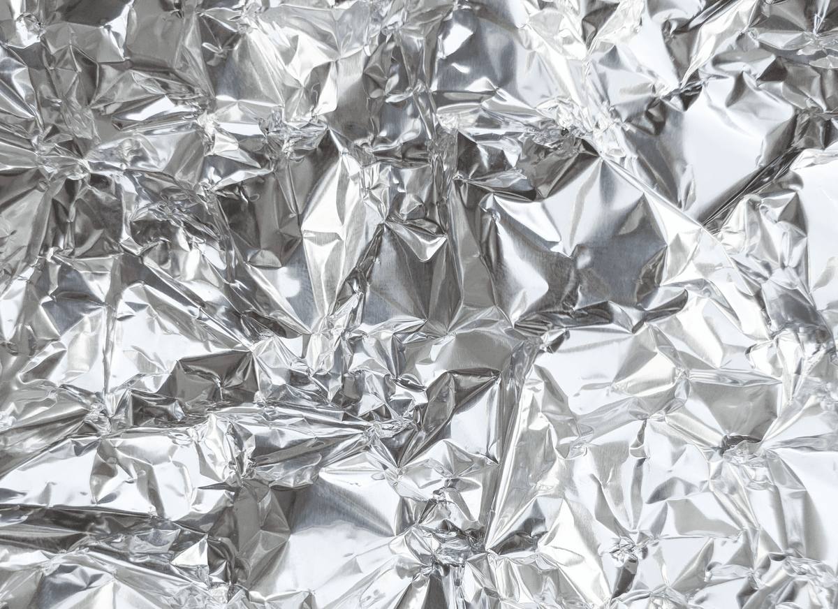 Close-up of crumpled silver aluminum foil filling the frame